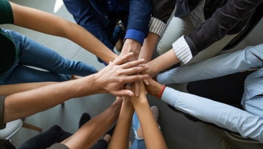 group of people hands in the middle