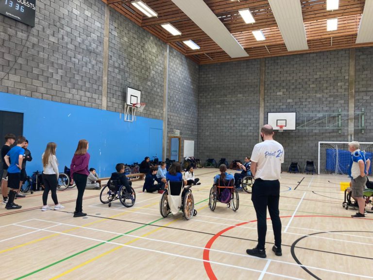 Young people and an adult leader in a sports hall