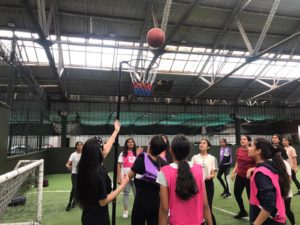 a group of young people playing basketball