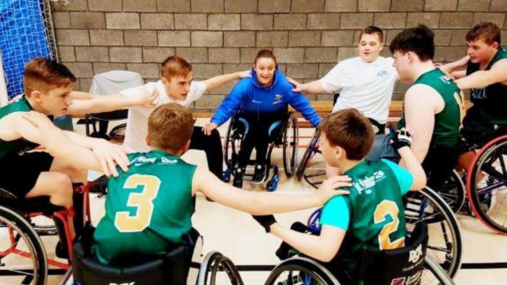 Young people in wheelchairs in a huddle