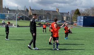 Young people playing football