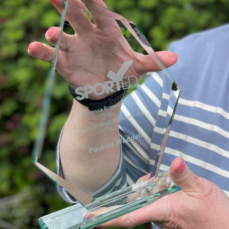 a woman's hands holding a glass Sported volunteer award