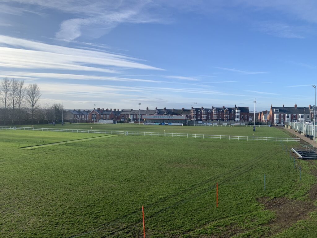 Photo of a cricket ground with blue skies in a little piece of heaven