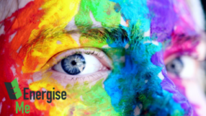 close up of a rainbow painted face with energise me logo in corner