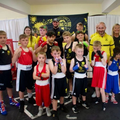 Group of young boxers with their gloves on and hands up ready to fight