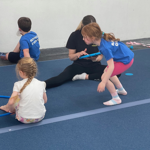 Three young children with a coach