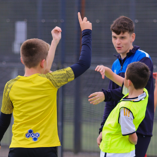 Male coach with two boys