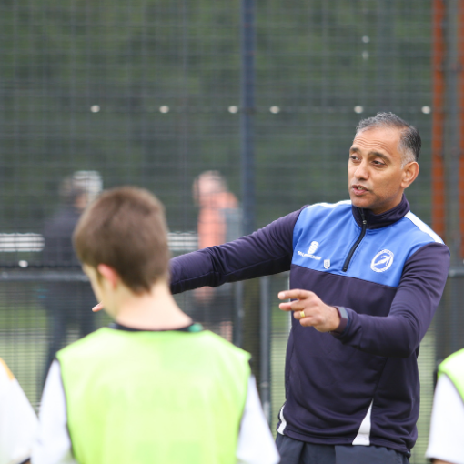 Male coach with male football players