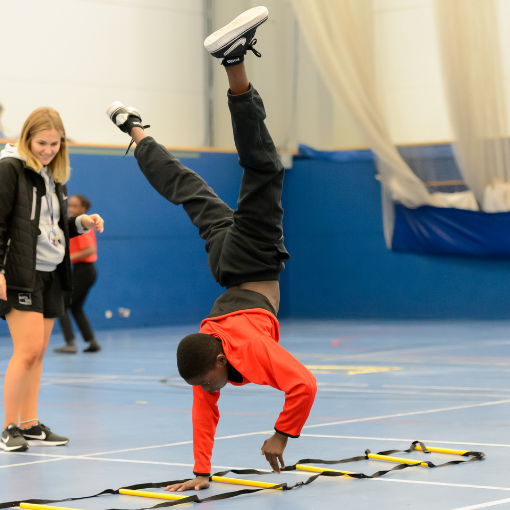 Young person walking on their hands