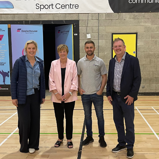 Sported staff with MSP and group leader in a sports hall