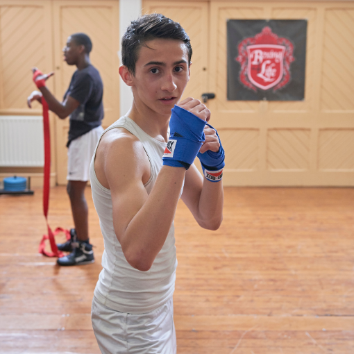 Boy sparring in a sports hall