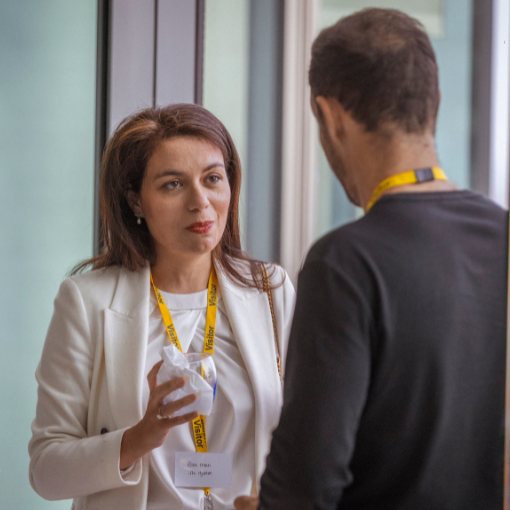 Woman talking to a man whilst holding a drinking glass