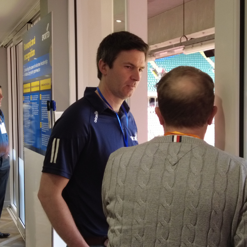 Man in Sported kit talking to another man