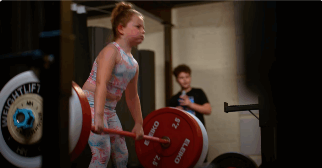 Young girl weightlifting