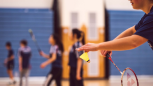 people playing badminton in a sports hall