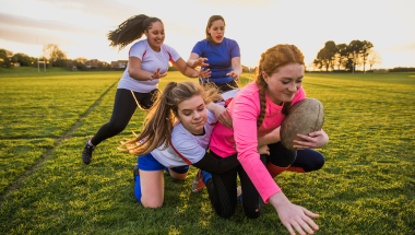 girls chasing a rugby ball