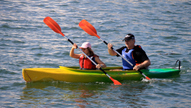 two people on a double kayak on open water