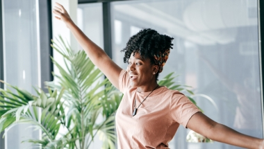 woman with her arms outstretched looking happy